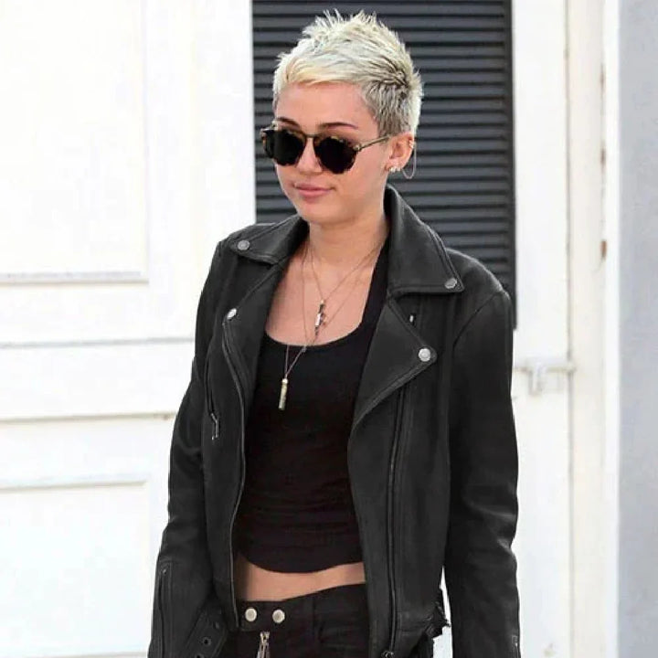 Person wearing a black leather jacket and sunglasses outdoors