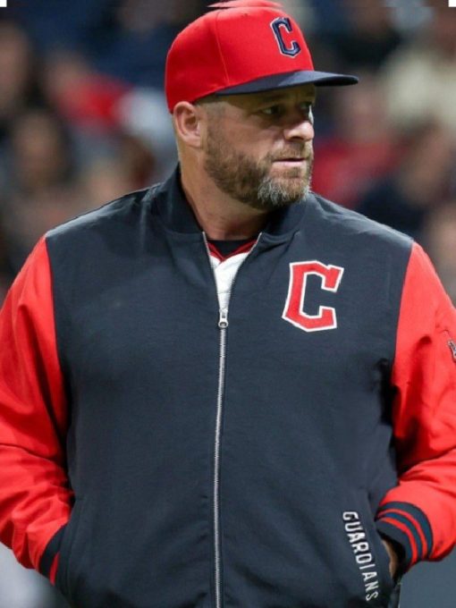 Person wearing a red and black jacket with a 'C' logo, likely at a sports event.