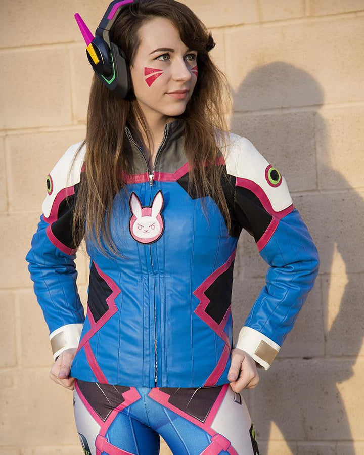 Person wearing a colorful costume with bunny emblem against a beige wall