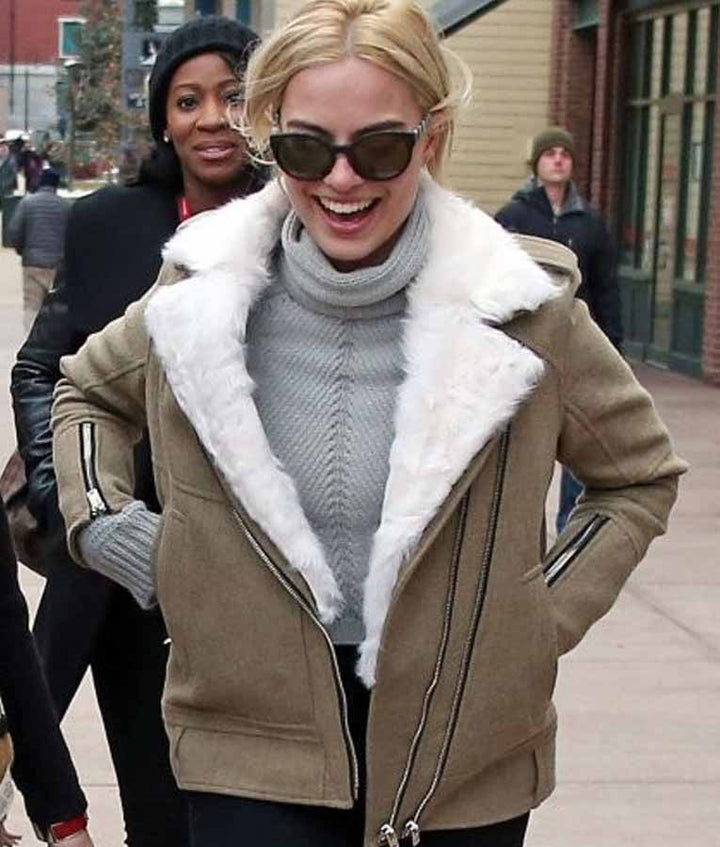 Woman wearing a beige coat with white fur lining in an urban setting