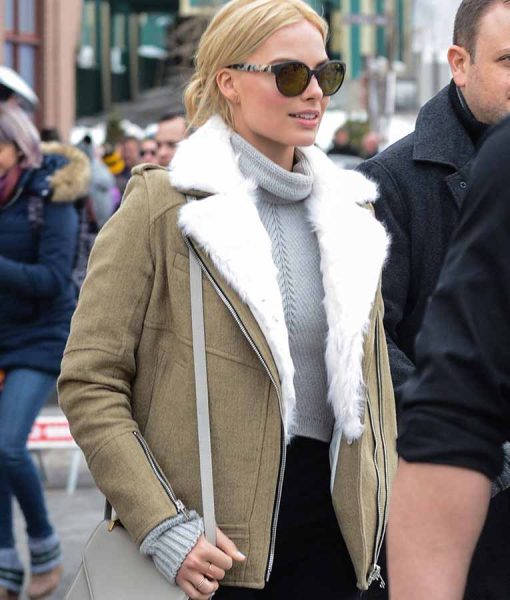 Woman wearing a beige coat with white fur lining in an urban setting