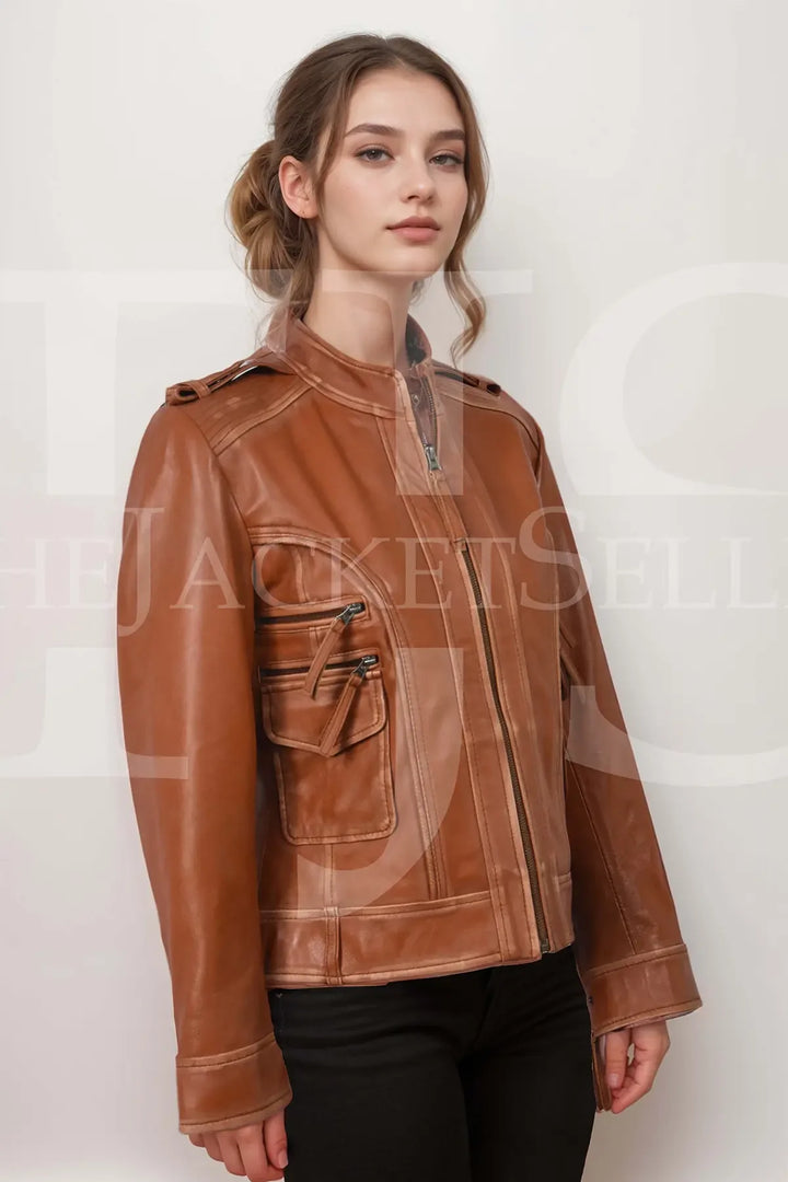 Front view of Women's Genuine Lambskin Leather Jacket in a rich tan color, showcasing multiple zippered pockets and stylish details