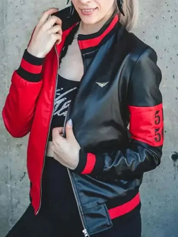 Person wearing a black and red jacket with a concrete wall background